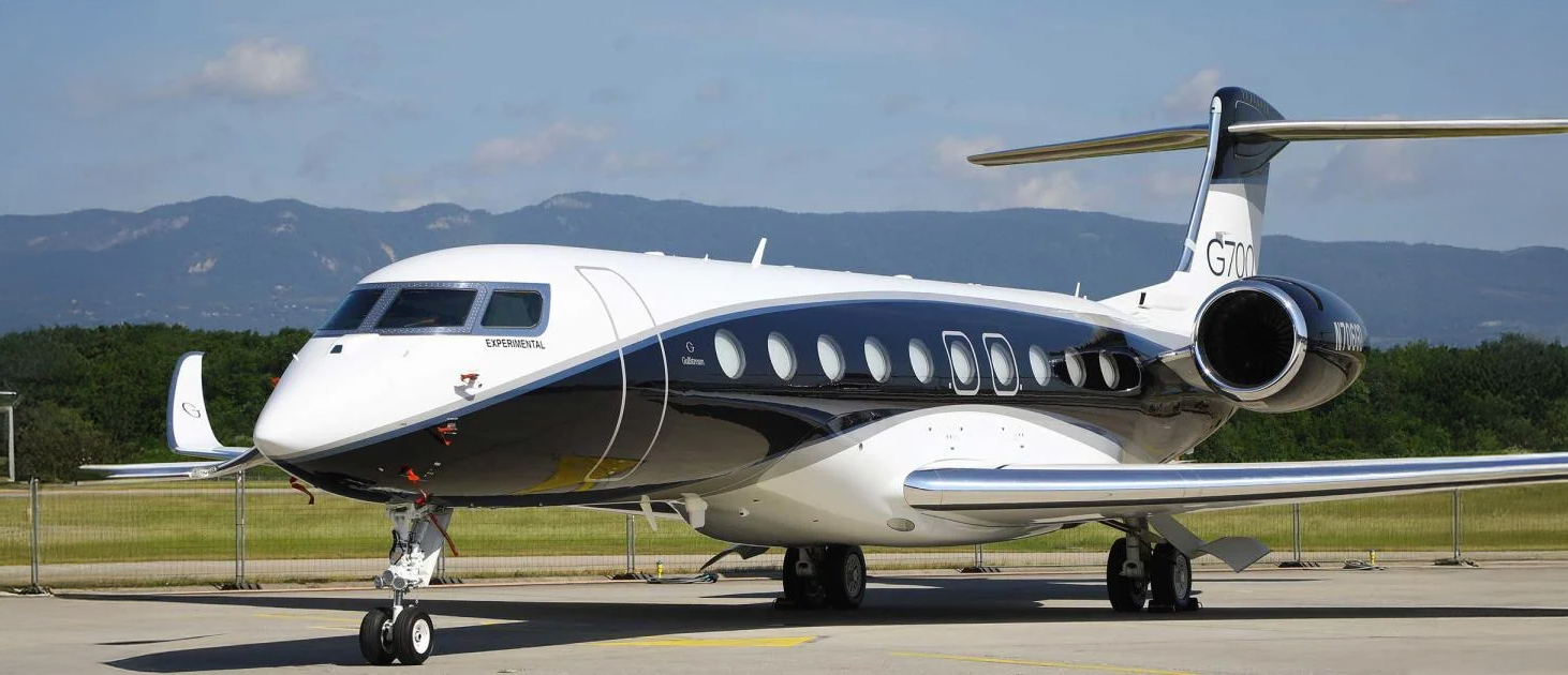 FAA-certified technician performing line maintenance on a private jet at the ramp